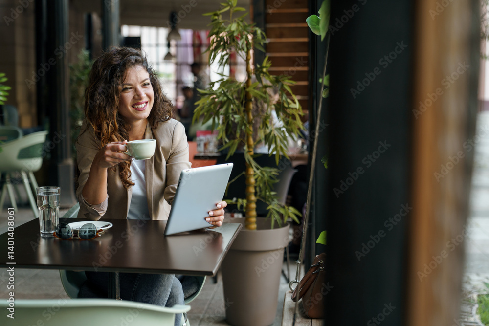 Smiling Woman Enjoying Coffee While Using Tablet in Light-Filled Eco-Friendly Coffee Shop Smiling Woman Enjoying Coffee While Using Tablet in Light-Filled Eco-Friendly Coffee Shop