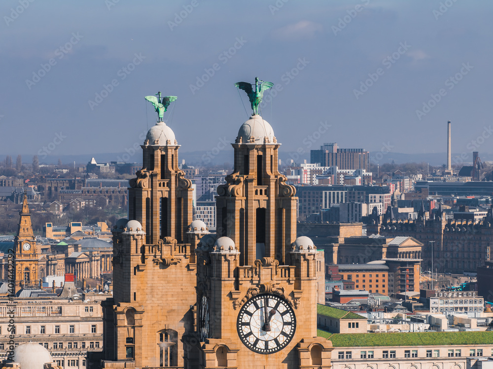 Aerial view of Liverpool showcasing the Royal Liver Building with its clock towers and Liver Birds, surrounded by historic and modern city structures.
