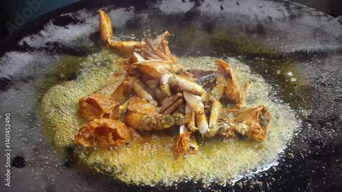 Hilsha fish is fried in a big pan along with shrimp and eggplant, Hilsha Fish and shrimp Simmering in mustard oil, traditional Bengali style fried hilsa and eggplant	