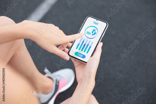 Obraz na płótnie Woman using step counting app on smartphone at stadium, closeup w salonie