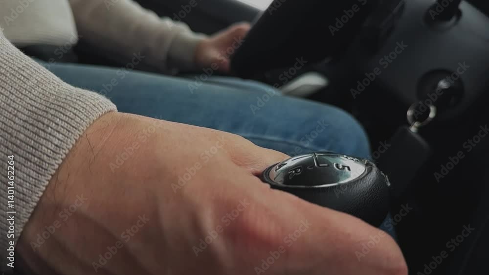 Male hand driving car with manual transmission road trip automobile travel closeup. Man driving riding auto transportation arms on steering wheel gearshift lever. Motor vehicle speed movement control Male hand driving car with manual transmission road trip automobile travel closeup. Man driving riding auto transportation arms on steering wheel gearshift lever. Motor vehicle speed movement control