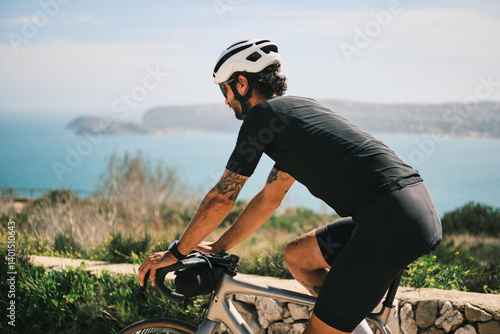 A cyclist enjoys a scenic coastal ride, showcasing stunning ocean views.  The image captures a sense of freedom and athleticism.