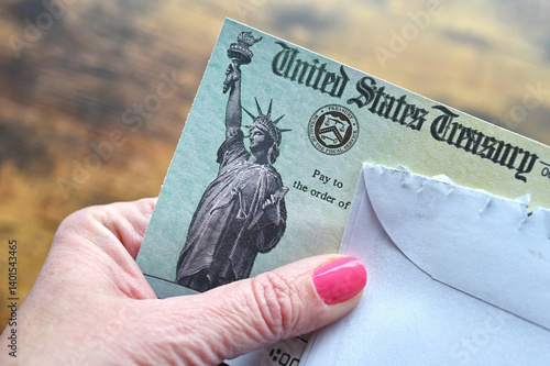 Female holding a check from the United States Treasury