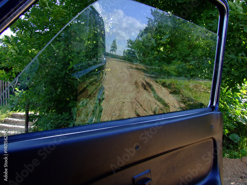 Rural Road: A Reflection of Nature in a Car Window