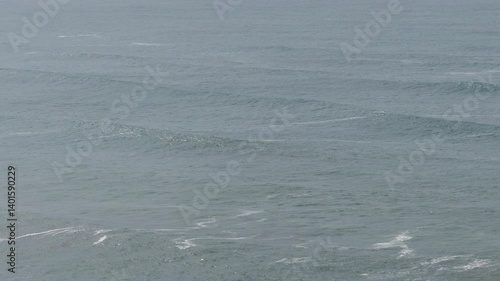 Waves roll into the shore of Newport, Oregon