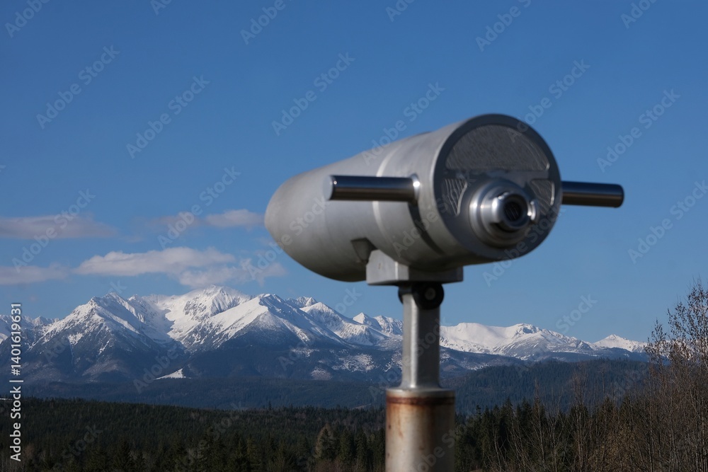Viewpoint Pass over Lapszanka with snow-capped peaks of High Tatras and Bialskie Tatras mountains and blurred binoculars in foreground, Poland