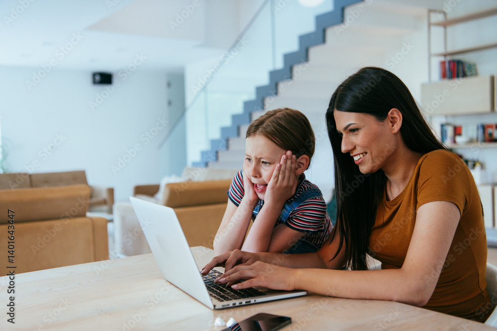 Mother with her daughter talking on laptop with family and friends while sitting in modern living room of big house.