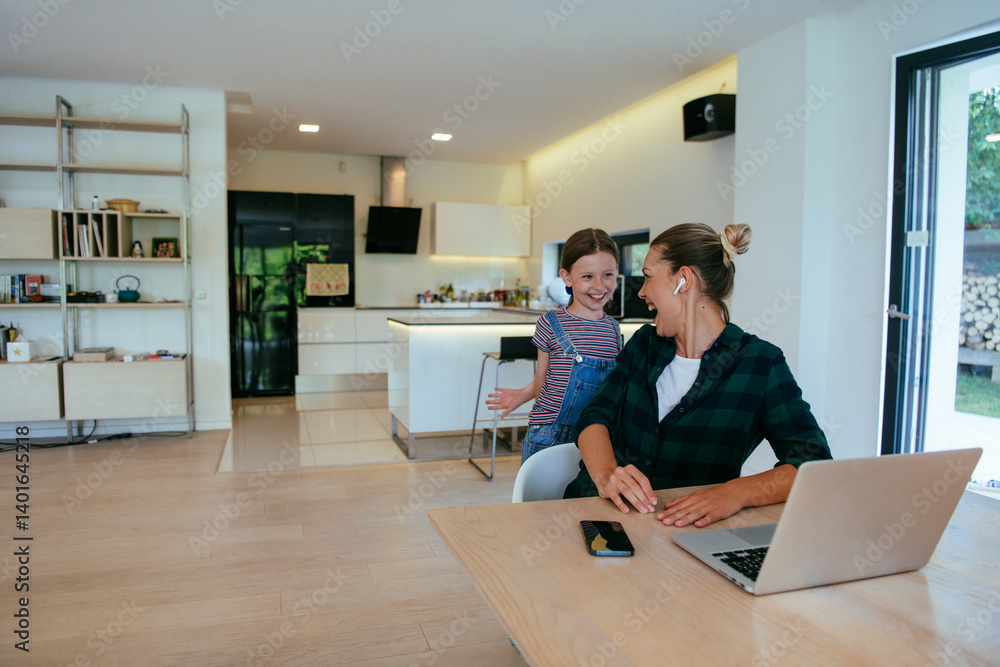 Mother with her daughter talking on laptop with family and friends while sitting in modern living room of big house.