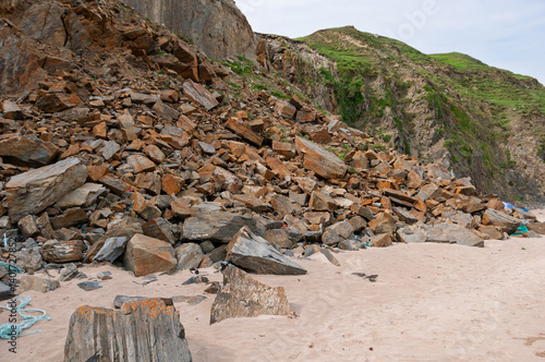 A rocky beach with a large pile of rocks on it