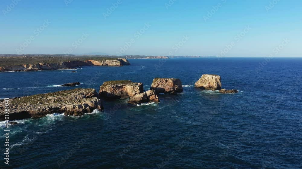 The rocky coast of the Algarve on the way to Sagres touches the ocean, in Europe, Portugal, Algarve, towards Albufeira, in summer, on a sunny day. The rocky coast of the Algarve on the way to Sagres touches the ocean, in Europe, Portugal, Algarve, towards Albufeira, in summer, on a sunny day.