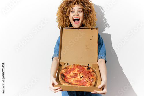 Excited young woman holding a pizza box with a delicious pizza, showcasing joy and enthusiasm for food, perfect for food advertising or social media content