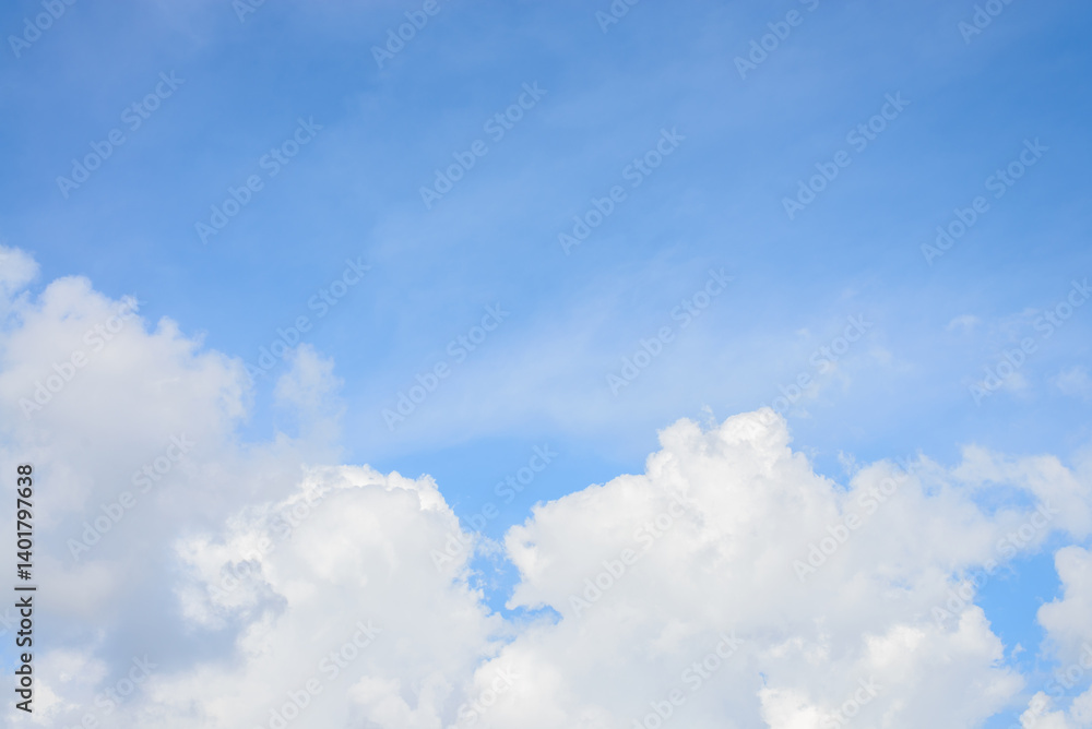 A clear blue sky filled with fluffy white clouds on a bright sunny day A clear blue sky filled with fluffy white clouds on a bright sunny day