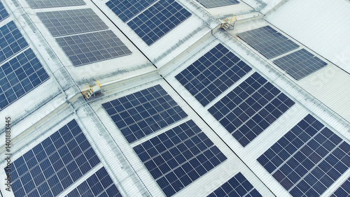 multiple solar panels installed on the rooftop of a building. The solar panels are arranged in neat rows and columns, with clear separations between each panel. 