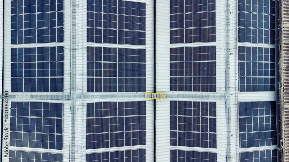 multiple solar panels installed on the rooftop of a building. The solar panels are arranged in neat rows and columns, with clear separations between each panel.