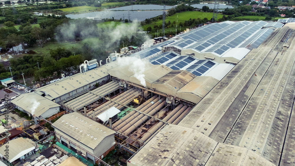 multiple solar panels installed on the rooftop of a building. The solar panels are arranged in neat rows and columns, with clear separations between each panel.
