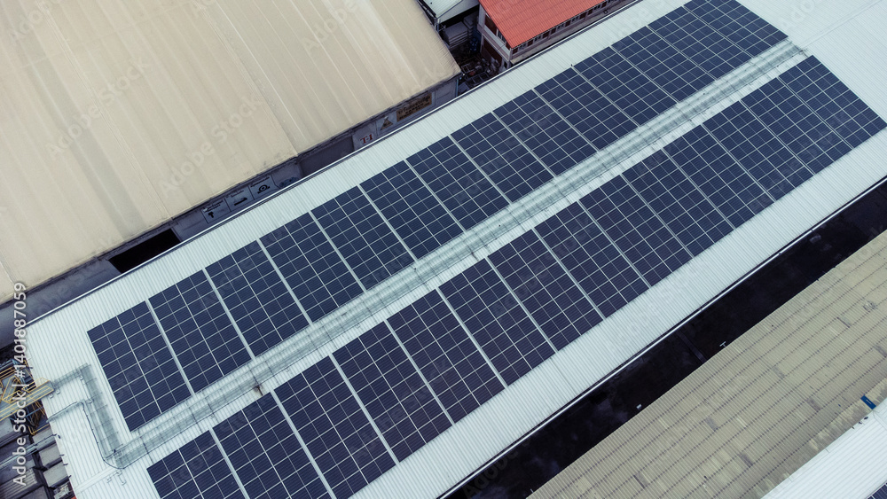 Obraz premium multiple solar panels installed on the rooftop of a building. The solar panels are arranged in neat rows and columns, with clear separations between each panel. 