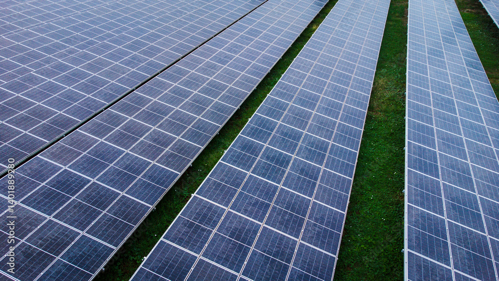 multiple solar panels installed on the rooftop of a building. The solar panels are arranged in neat rows and columns, with clear separations between each panel.