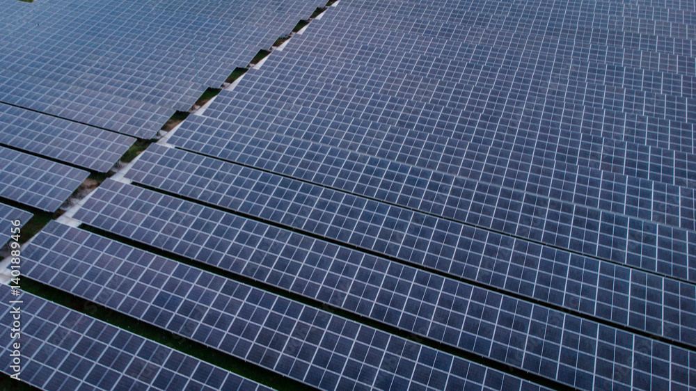 multiple solar panels installed on the rooftop of a building. The solar panels are arranged in neat rows and columns, with clear separations between each panel. multiple solar panels installed on the rooftop of a building. The solar panels are arranged in neat rows and columns, with clear separations between each panel.