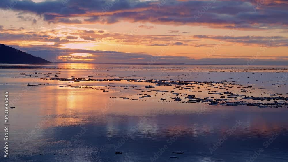 A timelapse of Turnagain Arm Alaska with golden hour colors and sea ice flowing with the tide. A timelapse of Turnagain Arm Alaska with golden hour colors and sea ice flowing with the tide.