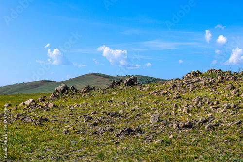 Khakassia. Old stone wall. Mountain landscape with blue sky