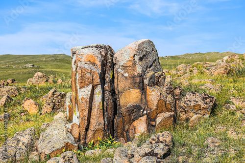 Khakassia. Old stone wall. Mountain landscape with blue sky