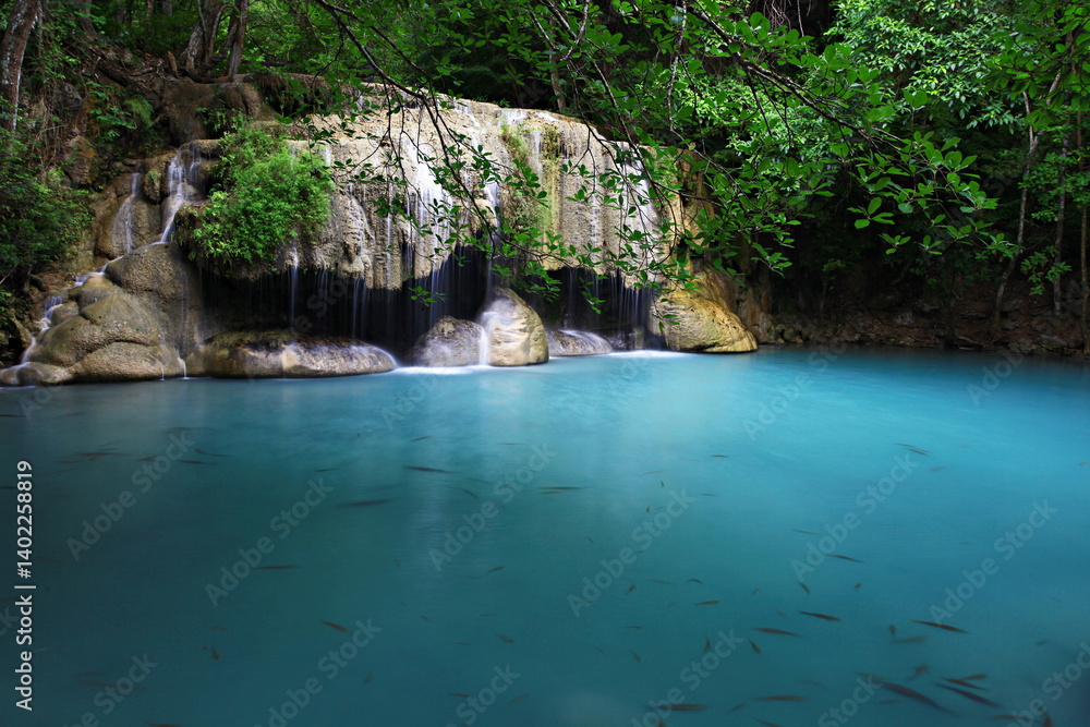 Naklejka premium Tropical landscape with beautiful waterfall, emerald lake and rocks in wild jungle forest. Erawan National park, Kanchanaburi, Thailand