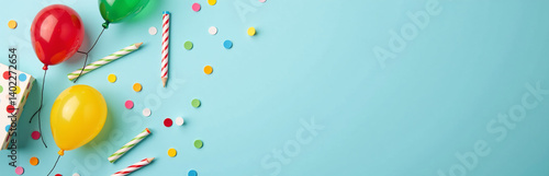 Obraz na płótnie A Colorful And Festive Birthday Setup Featuring Essential Party Items Arranged Artfully On A Soft Blue Tabletop Background. w salonie