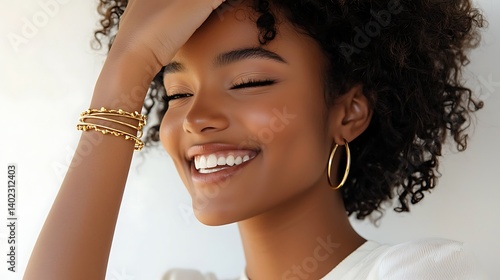 A woman with a gold bracelet on her left wrist and gold hoop earrings