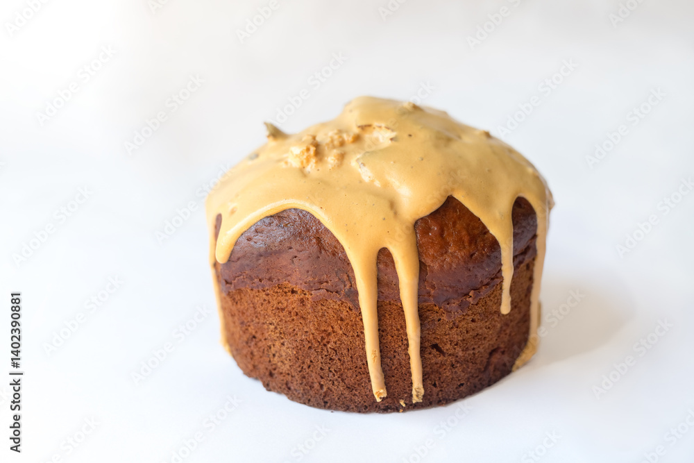 Delicious Easter Kulich cake with milk filling and raisins and candied fruit isolated on white background Delicious Easter Kulich cake with milk filling and raisins and candied fruit isolated on white background