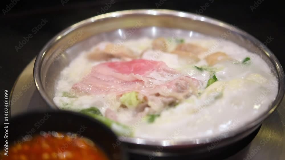 Cooking food by put a flesh beef, pork, egg and vegetable in to a hot pot for make a sukiyaki or shabu at japanese shabu buffet restaurant Cooking food by put a flesh beef, pork, egg and vegetable in to a hot pot for make a sukiyaki or shabu at japanese shabu buffet restaurant