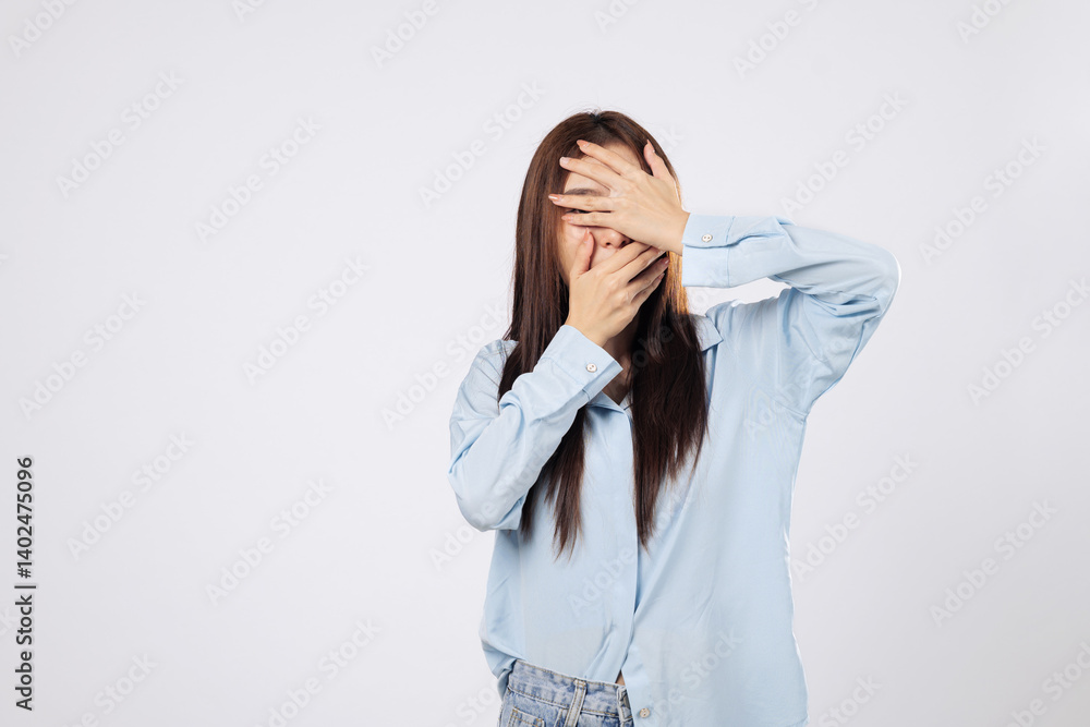 Covering face with hands, afraid woman shows panic while another woman peeks through fingers with fearful eyes, capturing raw emotion isolated on white background. Covering face with hands, afraid woman shows panic while another woman peeks through fingers with fearful eyes, capturing raw emotion isolated on white background.