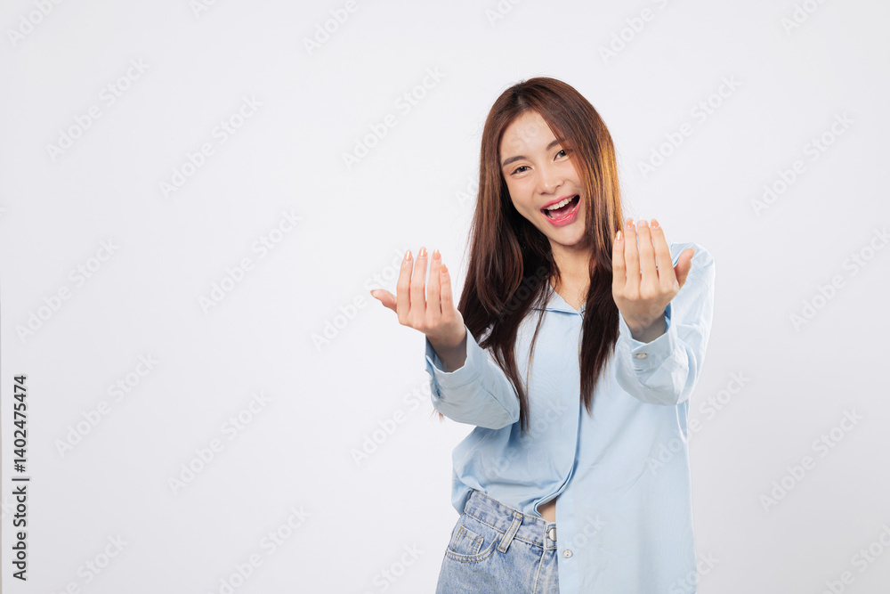 Woman uses hand gesture to beckon come here, while another woman stands with palm extended in a welcoming pose, cheerful expressions isolated in white studio background. Woman uses hand gesture to beckon come here, while another woman stands with palm extended in a welcoming pose, cheerful expressions isolated in white studio background.