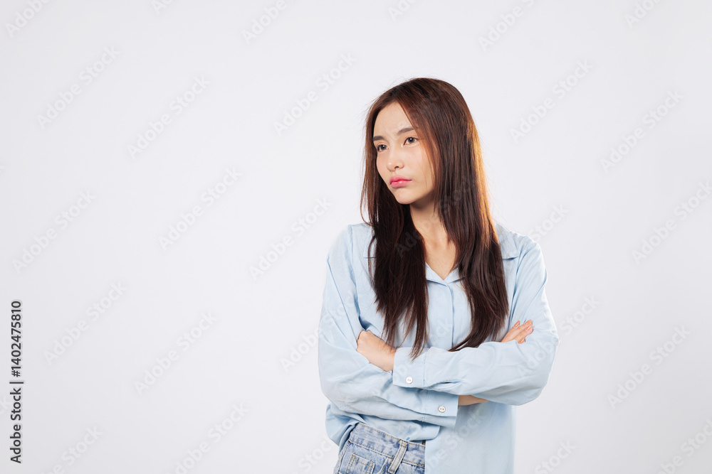 Crossed arms on angry woman, unhappy woman yells in fury, showing frustration and rage in a dramatic pose on isolated white studio background with empty space. Asian Crossed arms on angry woman, unhappy woman yells in fury, showing frustration and rage in a dramatic pose on isolated white studio background with empty space. Asian