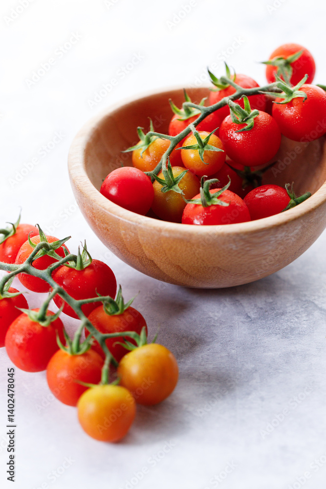 Fresh red cherry tomato in wooden bowl on white background. Fresh red cherry tomato in wooden bowl on white background.