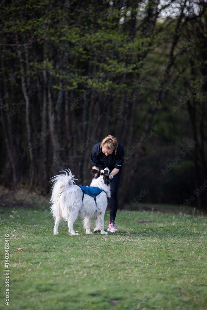 healthy fit woman in her forties running outdoors with her dog