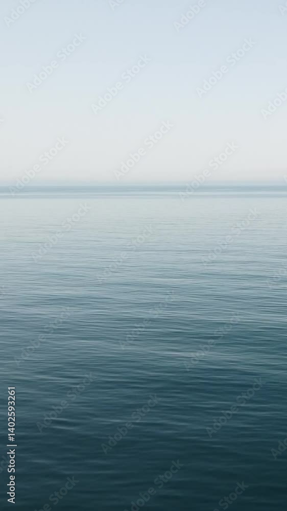 Sea water surface. Vertical aerial view, camera flies over calm sea with volcanic rocky shores. Abstract nautical summer ocean nature. Holiday and travel concept. Nobody. Weather and climate change Sea water surface. Vertical aerial view, camera flies over calm sea with volcanic rocky shores. Abstract nautical summer ocean nature. Holiday and travel concept. Nobody. Weather and climate change