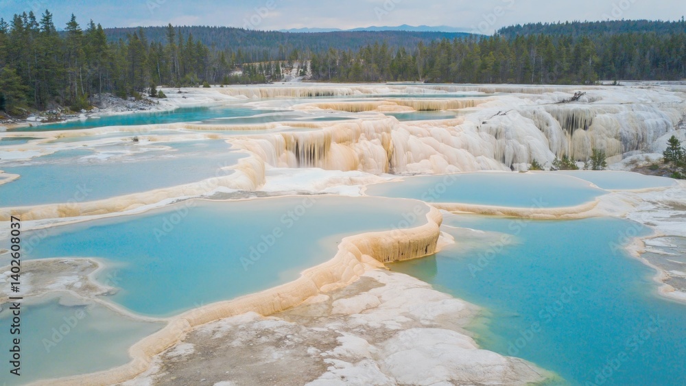 A picturesque view of the hot springs at Mammoth Hot Springs, Yellowstone National Park, Wyoming. Geysers and pools highlight this unique geological feature.