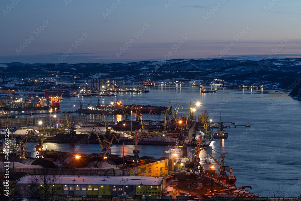View of the Kola Bay and Murmansk cargo port on a March evening