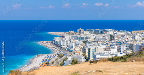 Rhodes Island panorama, city by the turquoise sea, sandy beaches stretch along the built environment beneath the bright sky. Beautiful distant view of Elli beach.