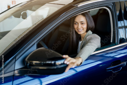 Φωτογραφία Millennial woman adjusting car side mirror while sitting inside new car in deale