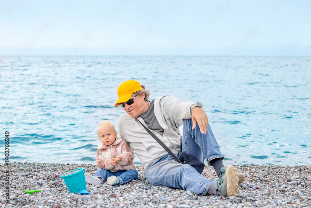 A man and his baby have a delightful day at the beach, creating lasting memories by the beautiful sea