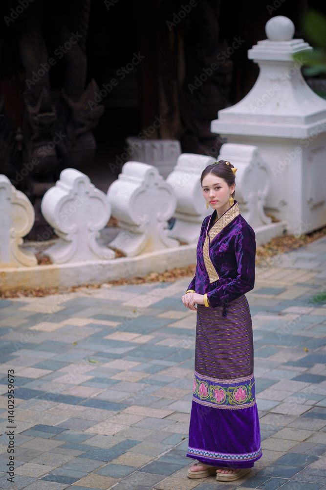 Fototapeta premium Pretty Asian women in traditional Thai dress. Beautiful conventional Thai dresses Lanna style. Fashion Thai dresses are popular with travellers in Chiang Mai, Thailand.