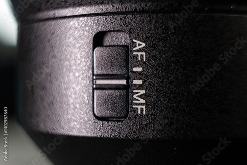 Closeup of the focus window on the camera lens. Close-up of the AF switch on the camera lens.