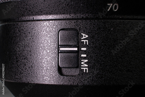 Closeup of the focus window on the camera lens. Close-up of the AF switch on the camera lens.
