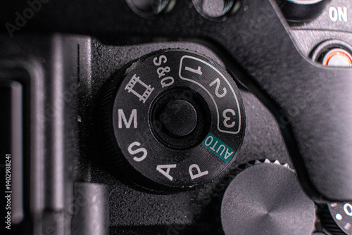 Close-up photo detail of a digital camera mode switch scroll wheel power button 