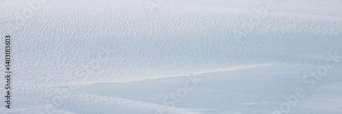 Obraz na płótnie Beautiful winter background with snowy ground. Natural snow texture. Wind sculpted patterns on snow surface. Wide panoramic texture for background and design. w salonie