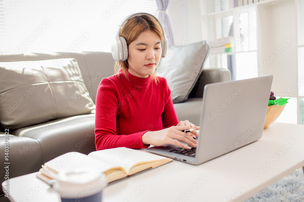 A cheerful Asian woman shows a credit card or an electronic payment online. A happy girl using a card A cheerful Asian woman shows a credit card or an electronic payment online. A happy girl using a card