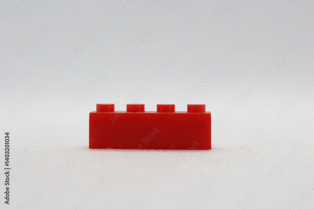 Naklejka premium Red lego brick isolated on a white background