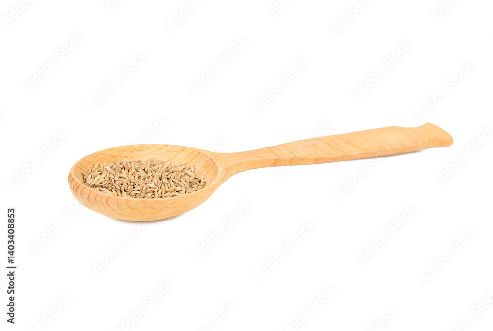 Cumin spice in a wooden spoon Cumin spice in a wooden spoon