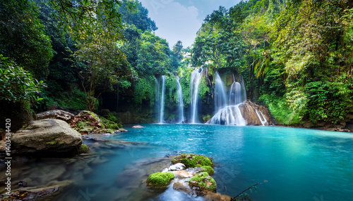 jungle waterfall cascade in tropical rainforest with rock and turquoise blue pond its name banyumala because its twin waterfall in mountain slope